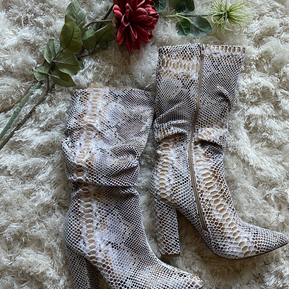 Liliana scrunch snakeskin pointed toes boots with a 4 in heel.
